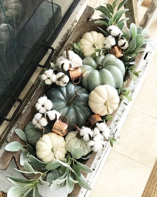A Dough Bowl With Pumpkins, Real And Faux Ones, Cotton, Greenery And Copper Mugs Is A Chic And Stylish Arrangement To Decorate A Space