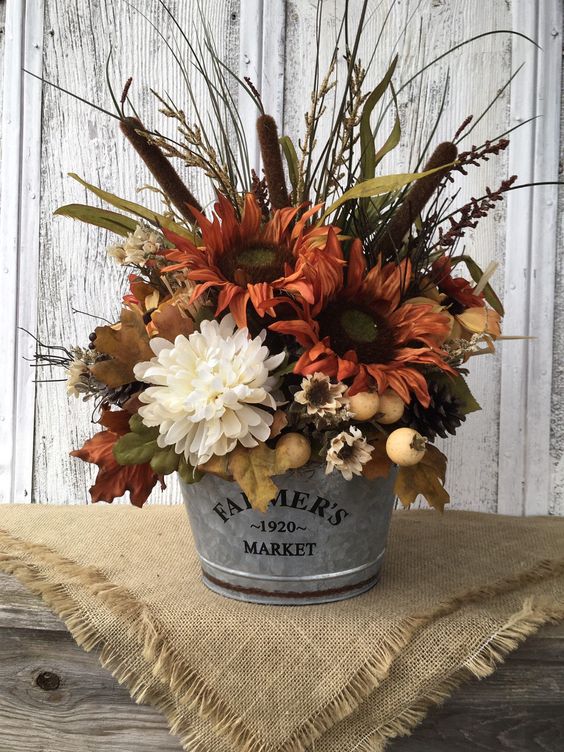 A Rustic Fall Arrangement Of Rust And White Faux Blooms, Berries, Grasses, Leaves And Other Stuff Looks Very Cozy