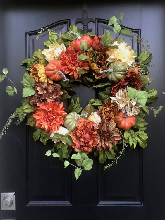 A Stylish Fall Wreath Of Greenery, Faux Pumpkins And Bright Blooms Is A Cool Decoration To Rock