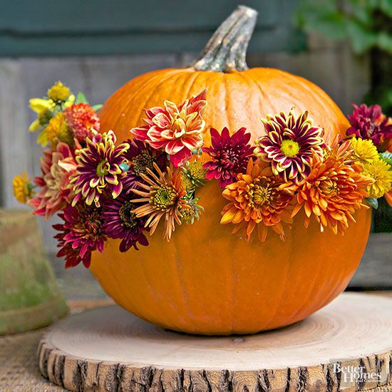A Natural Pumpkin With Bright Fall Blooms Inserted For Decor Is A Stylish Fall Centerpiece Idea To Rock