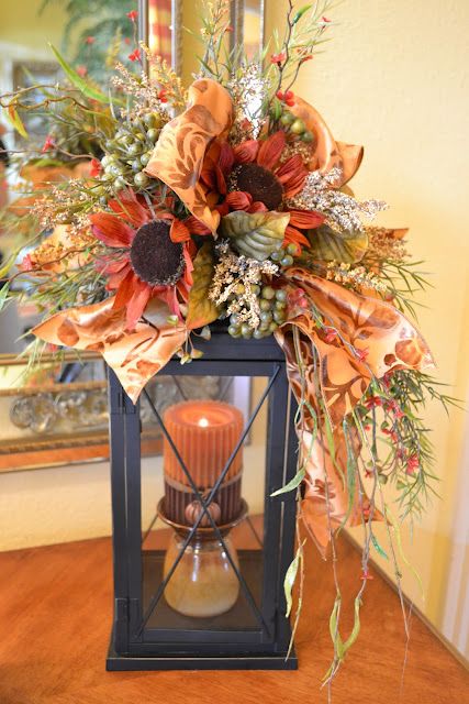 A Fall Candle Lantern With A Rust-Colored Candle, Dried Grasses, Berries And Faux Blooms And Plaid Ribbons For The Fall