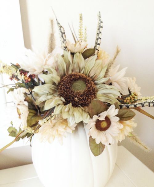 An Elegant Fall Centerpiece Of A White Pumpkin, Faux Blooms, Foliage And Dried Touches Is A Stylish Centerpiece Idea