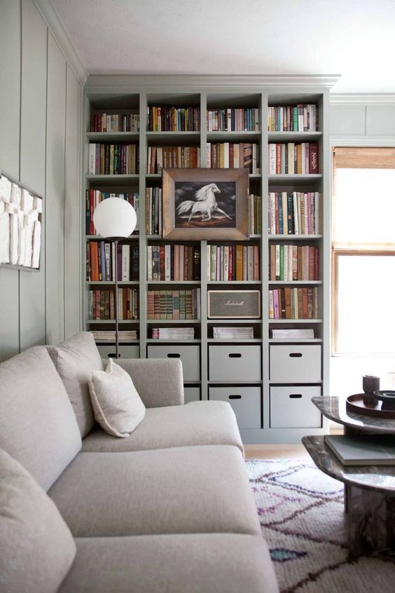 A Built-In Bookshelf Unit With Box Drawers And A Large Artwork On It Is Perfect For A Contemporary Space