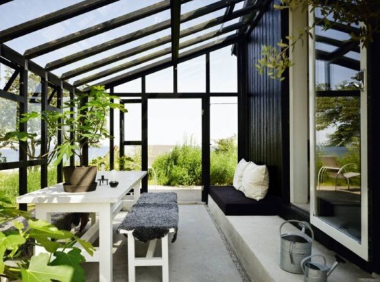 A Nordic Sunroom With Glazed Walls, Simple And Modern White Furniture, Greenery Is An Adorable Space To Stay
