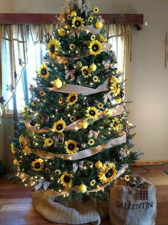 a fall tree decorated with faux sunflowers, lights, ribbon bows, burlap bows and bright yellow ornaments