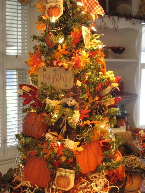 a creative vintage-inspired Thanksgiving tree with lights, faux leaves, pumpkins, signs, paper pumpkins