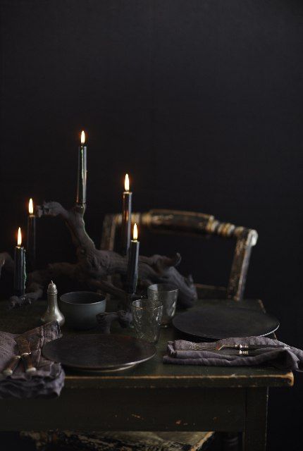 A Moody Black Halloween Tablescape With Black Candles, Plates, Napkins, Glasses And Bowls Is Very Chic