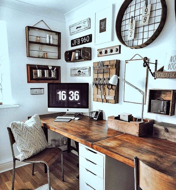 A Rustic Vintage Home Office With A Shared Desk, Some Art On The Wall, Wooden Chairs And Lots Of Rustic Decor