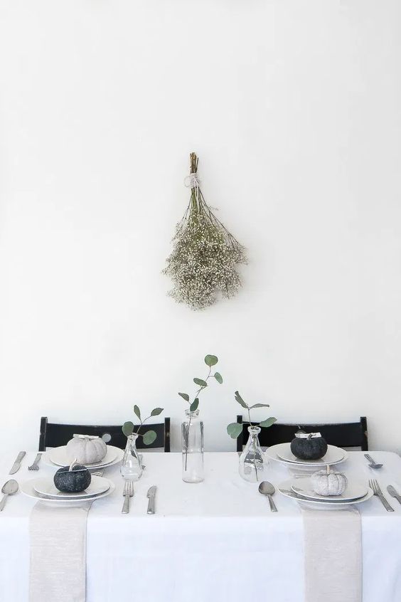 A Modern To Minimalist Thanksgiving Tablescape With Grey And Black Pumpkins, Greenery And Neutral Linens Is Laconic And Stylish