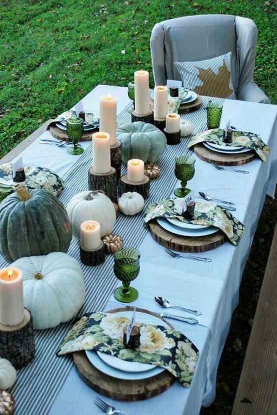 A Natural Thanksgiving Tablescape With A Green Uncovered Table, A Burlap Runner, Wood Slice Placemats And Carved Pumpkins With Soup
