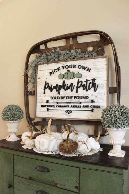 Rustic Thanksgiving Decor With Greenery, A Basket With A Sign, White And Rust Colored Pumpkins Feels Vintage And Chic