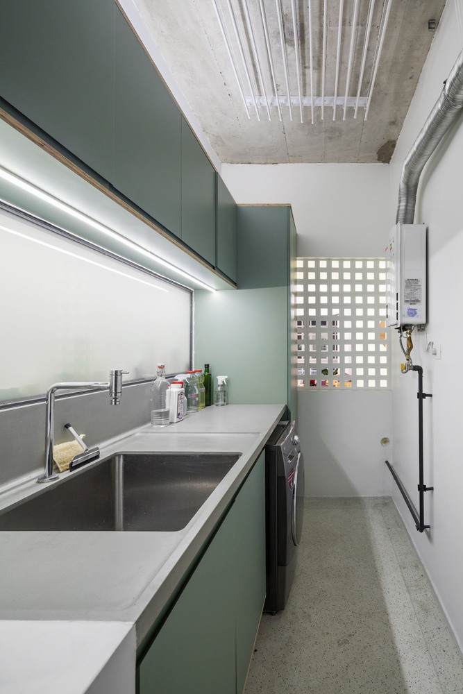 The Laundry Features Sleek Green Cabinets And Concrete Countertops Just Like The Kitchen