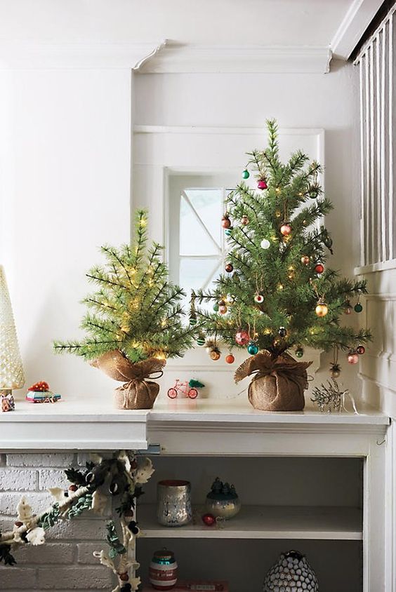 pretty tabletop Christmas trees - one decorated with lights, another one with small colorful ornaments and lights