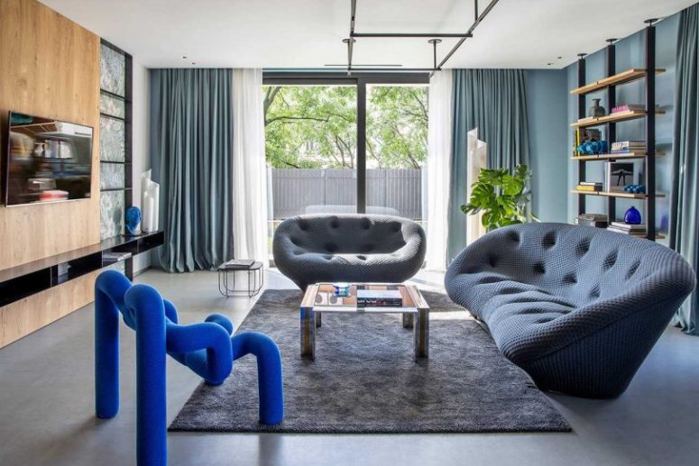 The Living Room Is Done With Slate Grey Sofas, An Industrial Shelf And A Gorgeous Electric Blue Chair That Steals The Show